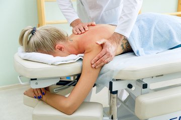 Изображение массажиста и пациента на сеансе массажа